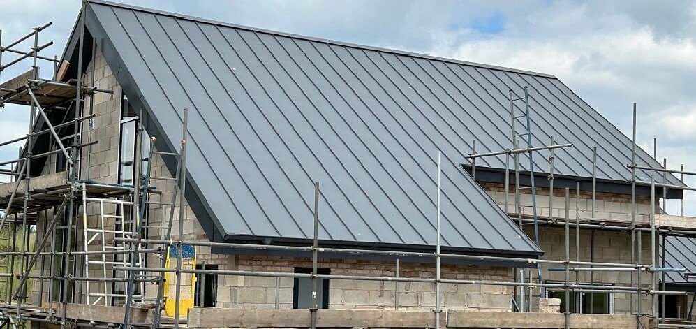 Standing seam metal roof construction